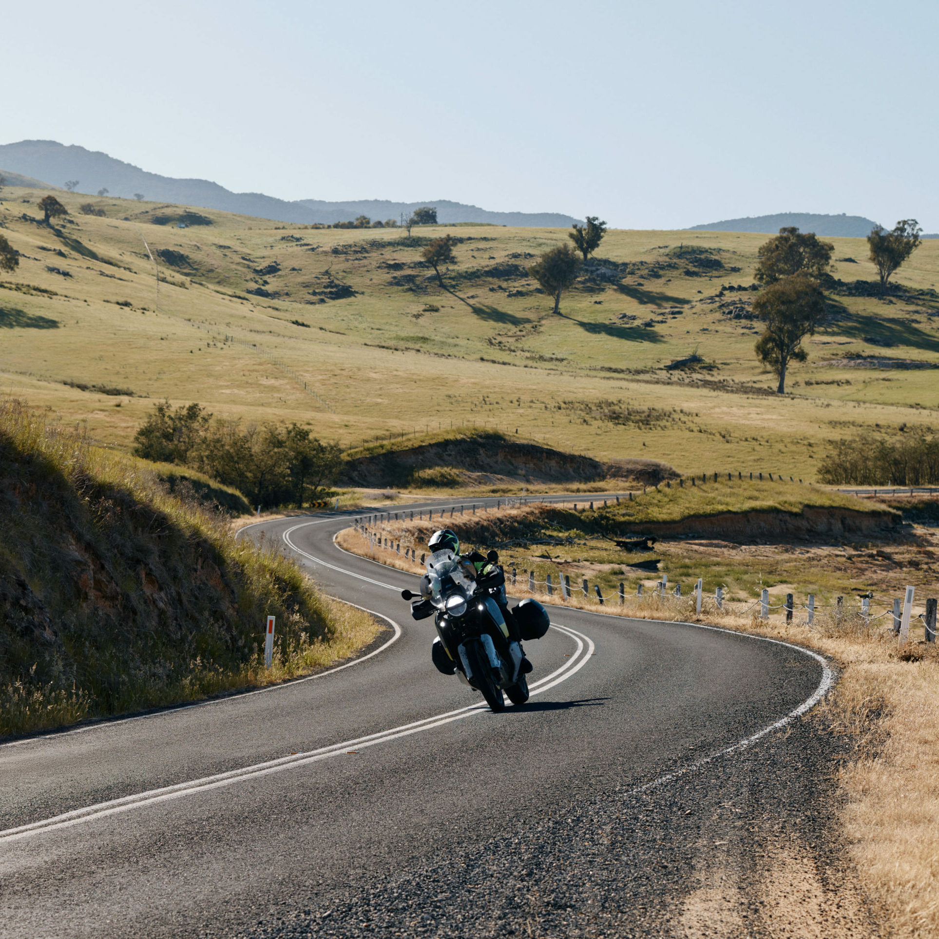 Motorbike leaning into a tight bend on The Great River Road, capturing the thrill of riding along a scenic route by the Murray River.